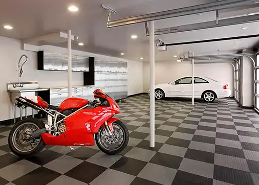 A sports bike parked on a black and alloy GarageDeck floor.