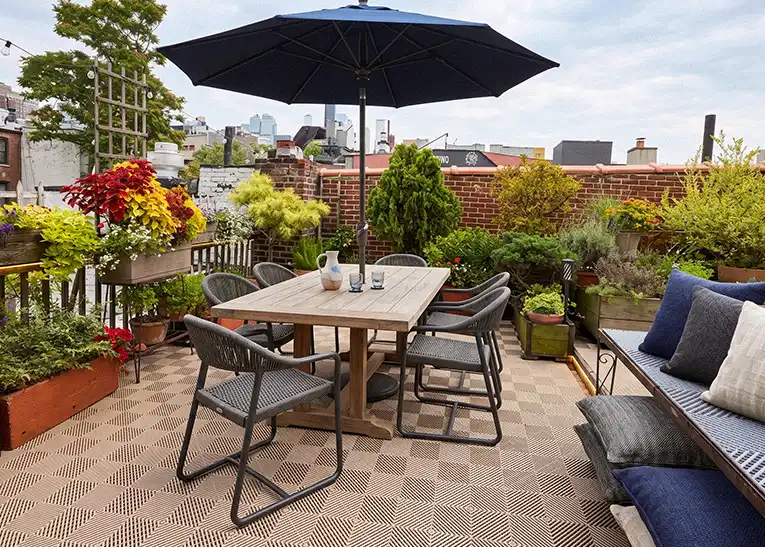 A rooftop deck with patio furniture and Duragrid Deck Tile.